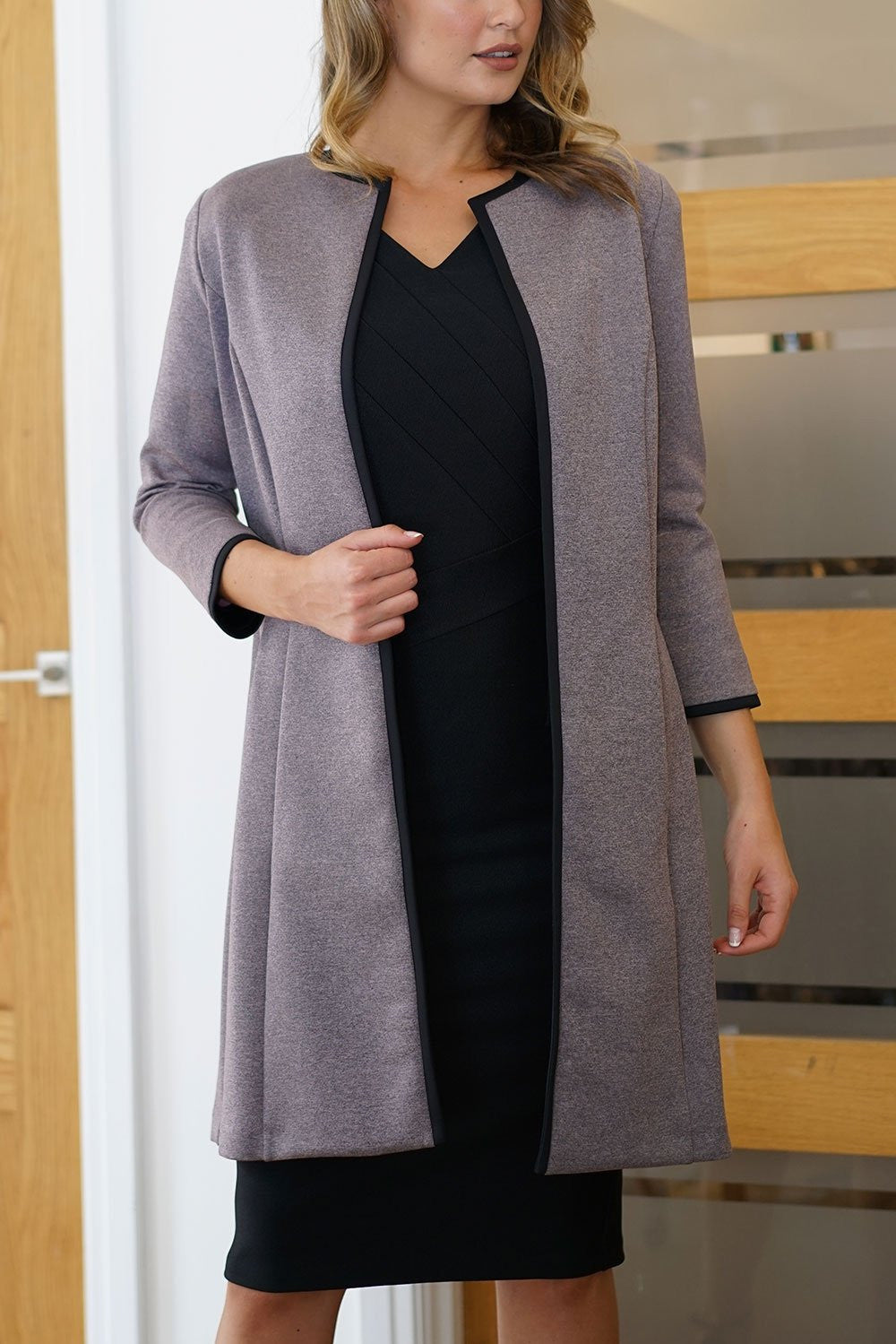 Model wearing the Diva Alverstone Coat in Mist Pink and black front image    