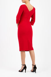 A model is wearing a three quarter sleeve pencil dress with a round neckline and bow detail at the front in red back image