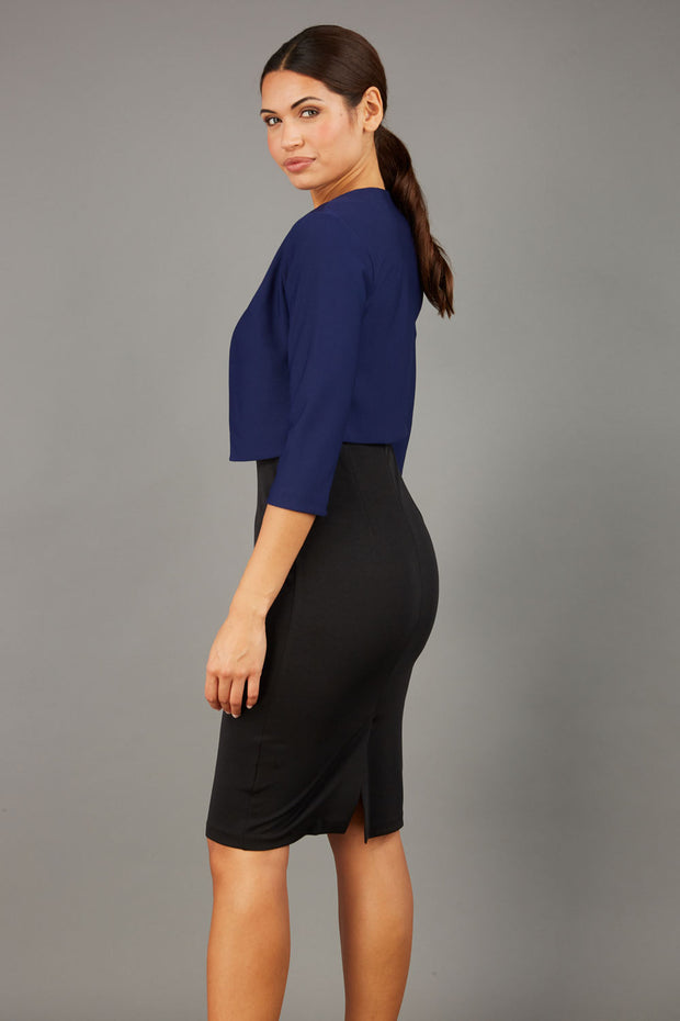 brunette model wearing diva catwalk navy sleeved bolero over a little black pencil dress front