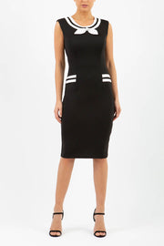 model wearing diva catwalk black and white tempo pencil dress with pocket detail and rounded neckline with bow detail front
