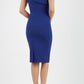 brunette model wearing diva catwalk rosita pencil skirt fitted dress with asymmetric neckline and bow detail at the top and it is a sleeveless design  with empire waistline in navy blue back