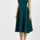 Model wearing the Diva Chesterton Sleeveless dress with oversized collar detail and swing pleated skirt in forest green front image