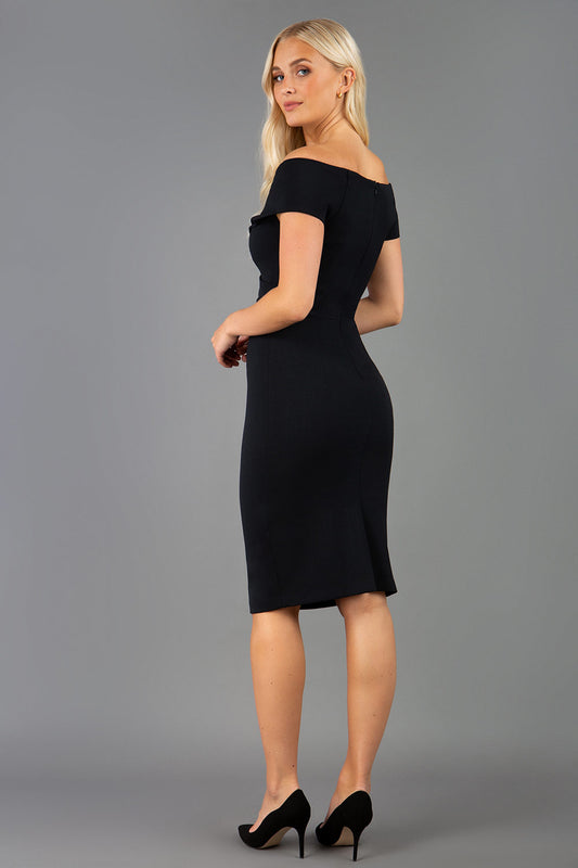 Model is wearing an off shoulder pencil dress by Diva Catwalk in black back image