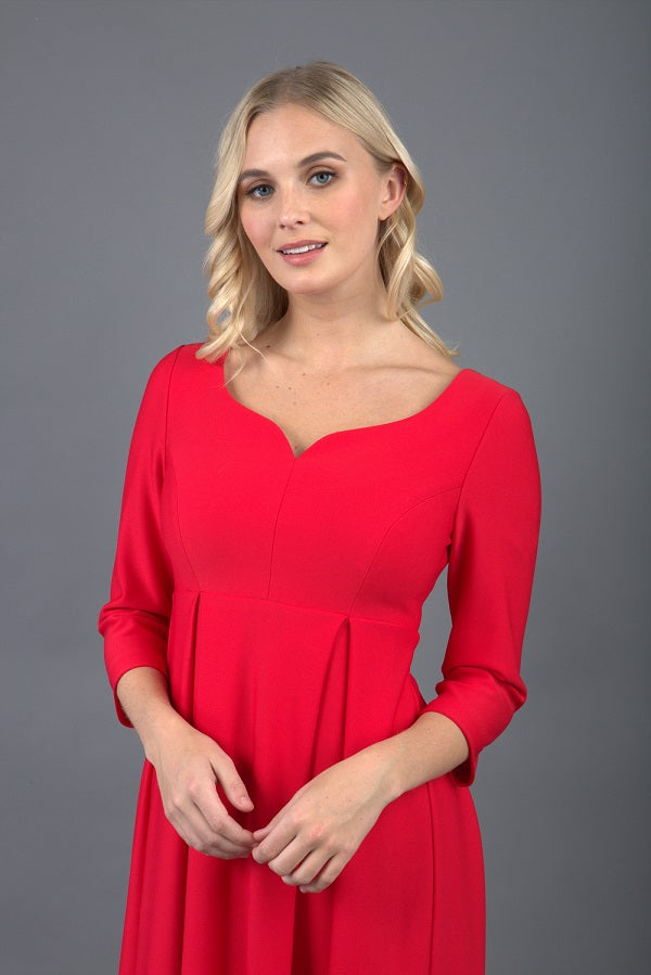 Brunette Model is wearing 3/4 sleeve sweetheart neckline swing electric red dress