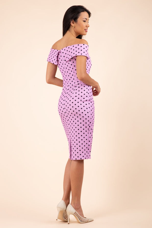 Brunette model wearing Diva Catwalk Fenella Polka Dot Pencil Sleeveless Dress off shoulder bardot neckline in pink back