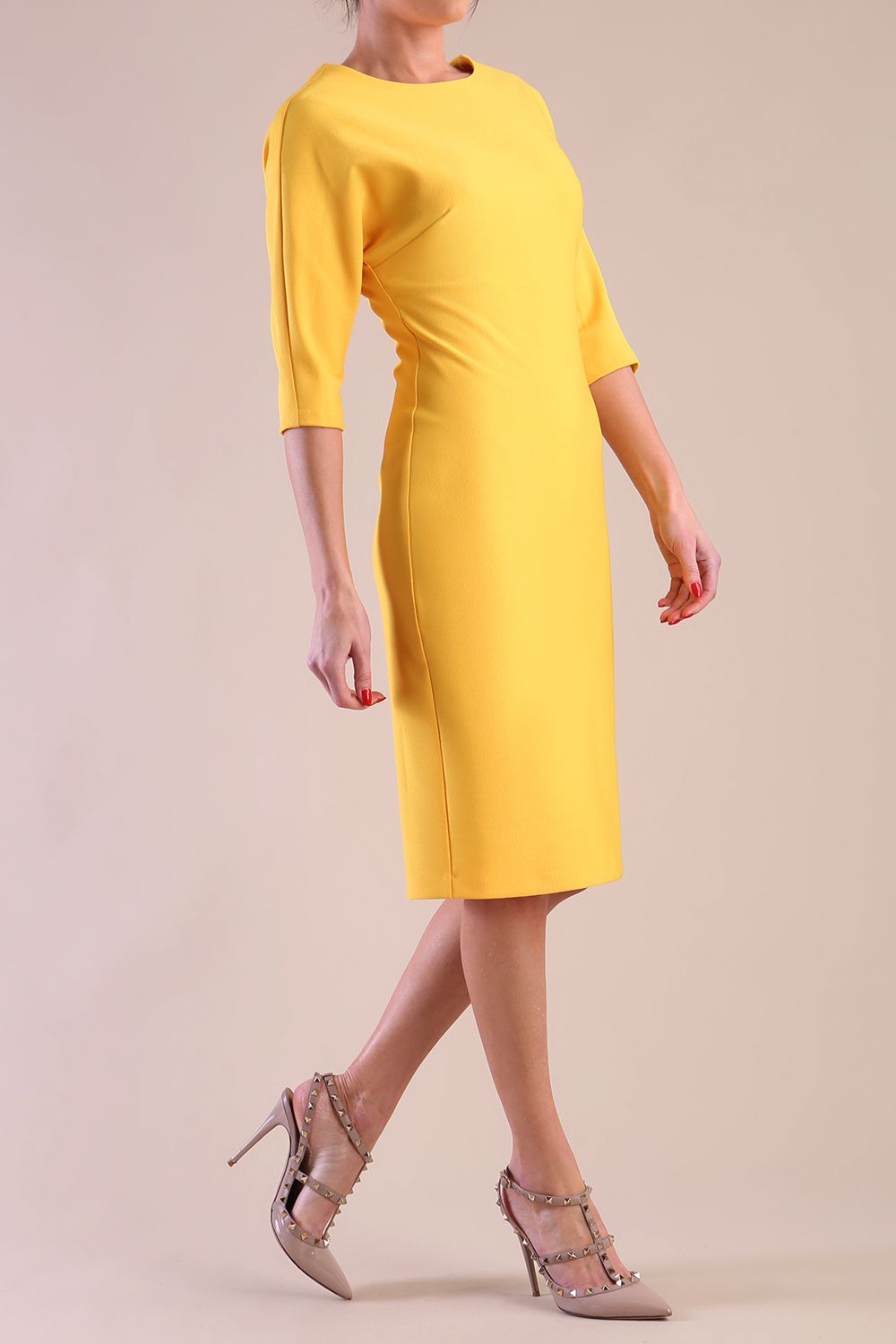 Model wearing diva catwalk Fulham 3/4 Sleeved pencil skirt dress with round neck in Daffodil Yellow