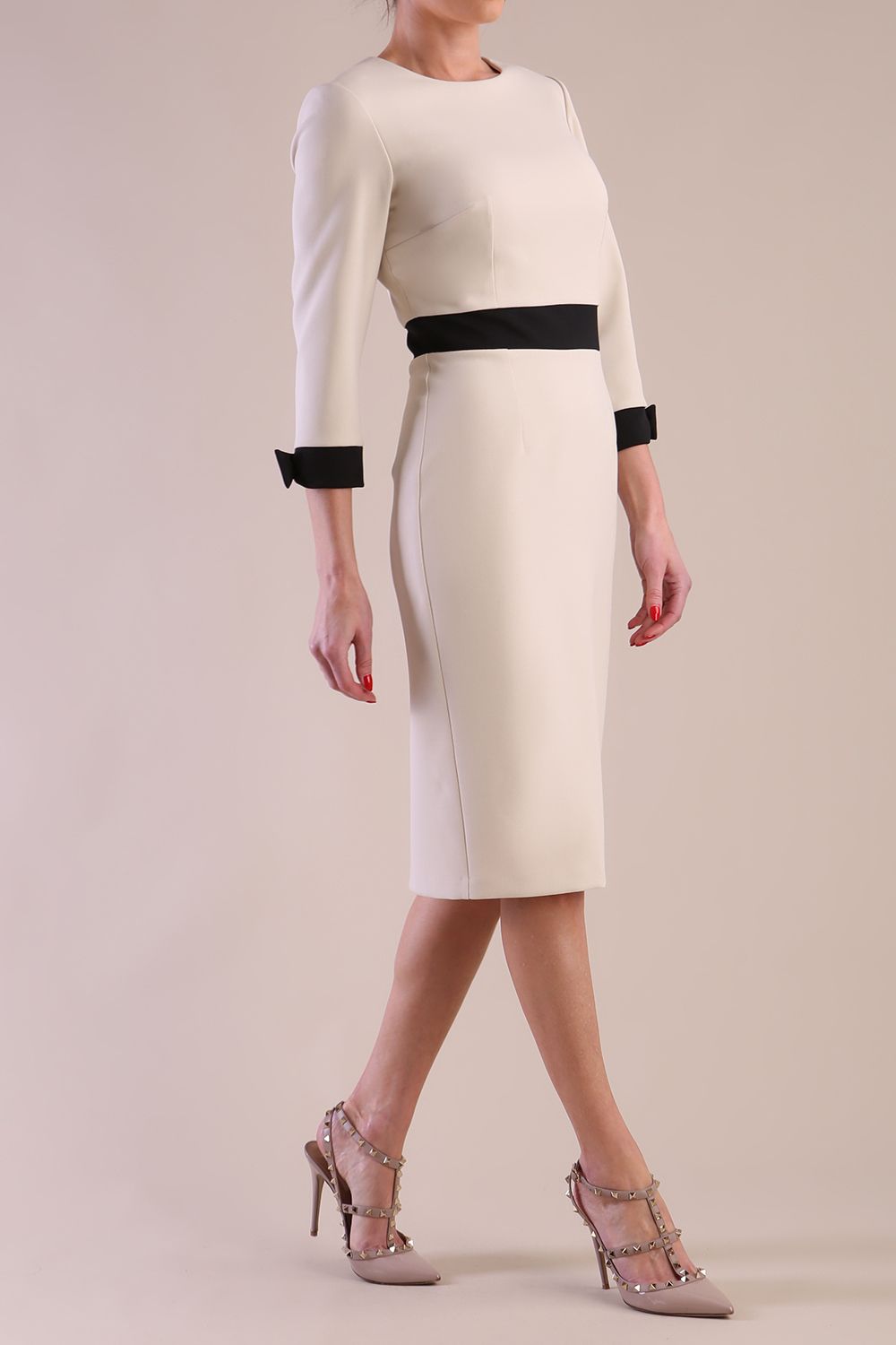 Model wearing diva catwalk Reese 3/4 Sleeved pencil skirt dress with a contrast sleeve and waistband details in Sandshell Beige/Black