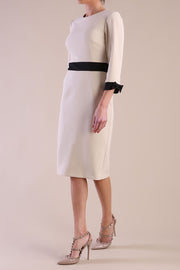 Model wearing diva catwalk Reese 3/4 Sleeved pencil skirt dress with a contrast sleeve and waistband details in Sandshell Beige/Black
