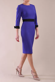 Model wearing diva catwalk Reese 3/4 Sleeved pencil skirt dress with a contrast sleeve and waistband details in Indigo Blue/Black