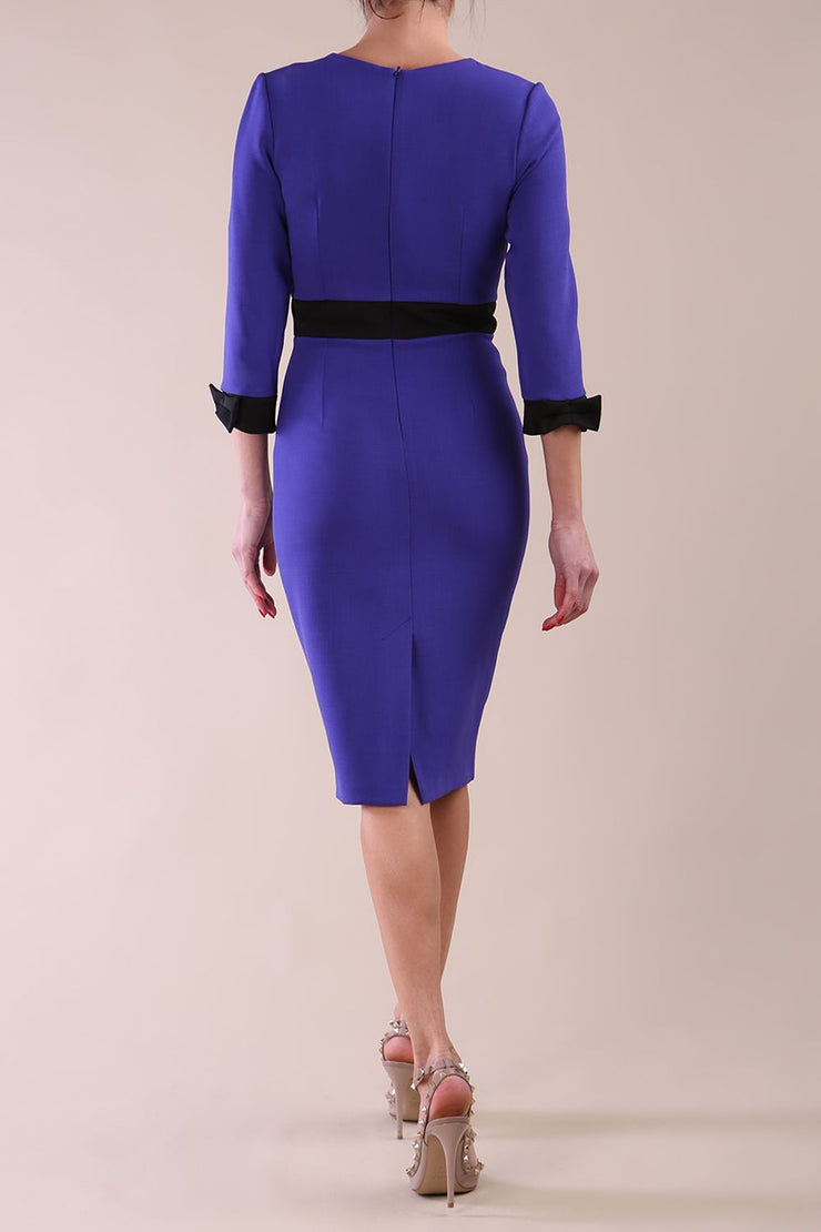 Back Image of Model wearing diva catwalk Reese 3/4 Sleeved pencil skirt dress with a contrast sleeve and waistband details in Indigo Blue/Black