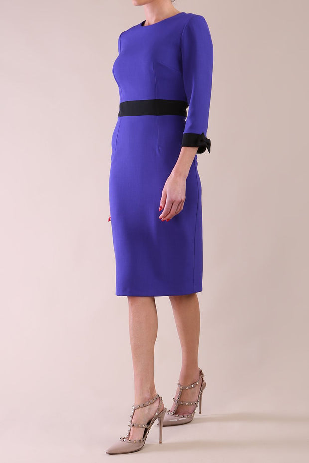 Model wearing diva catwalk Reese 3/4 Sleeved pencil skirt dress with a contrast sleeve and waistband details in Indigo Blue/Black