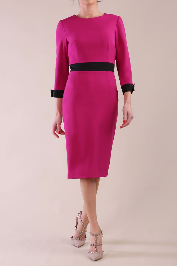 Model wearing diva catwalk Reese 3/4 Sleeved pencil skirt dress with a contrast sleeve and waistband details in Magenta/Black