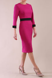 Model wearing diva catwalk Reese 3/4 Sleeved pencil skirt dress with a contrast sleeve and waistband details in Magenta/Black