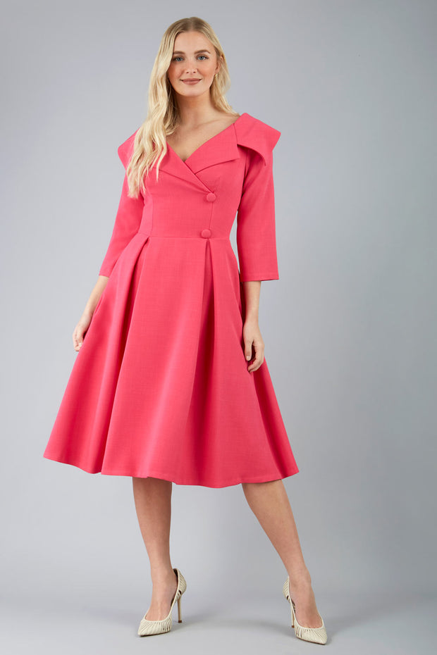 model is wearing a sleeved beige oversized collar swing dress with button detail at the front and pockets in the skirtmodel is wearing diva catwalk gatsby swing dress with pocket detail and wide v-neck collar and buttons down the front panel in pink front