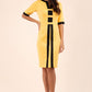 brunette model wearing Diva catwalk goggle pencil dress with short sleeve and v-neckline with contrasted design across body in yellow front