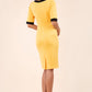 brunette model wearing Diva catwalk goggle pencil dress with short sleeve and v-neckline with contrasted design across body in yellow back