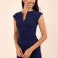 brunette model wearing diva catwalk lydia sleeveless pencil flattering fitted plain dress with split neckline and pleating across the body in navy blue front