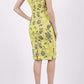 Model wearing the Diva Adeline Shift dress with V-neckline with a trim in Citronelle Green back image 