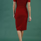 brunette model wearing diva catwalk amorette pencil skirt dress with a cold shoulder detaul and pleating across the bust and slit on a side of skirt in rosewood red colour back