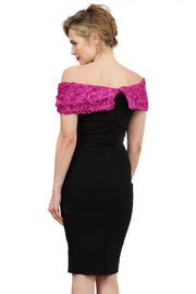 Model wearing the Diva Cornelli Perth dress with cornelli lace top, off shoulder design and diamanté brooch in black and fushia pink back image