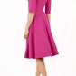 Model wearing the Diva Annette Swing Dress with V shaped neckline with zip detail in fuschia pink back image