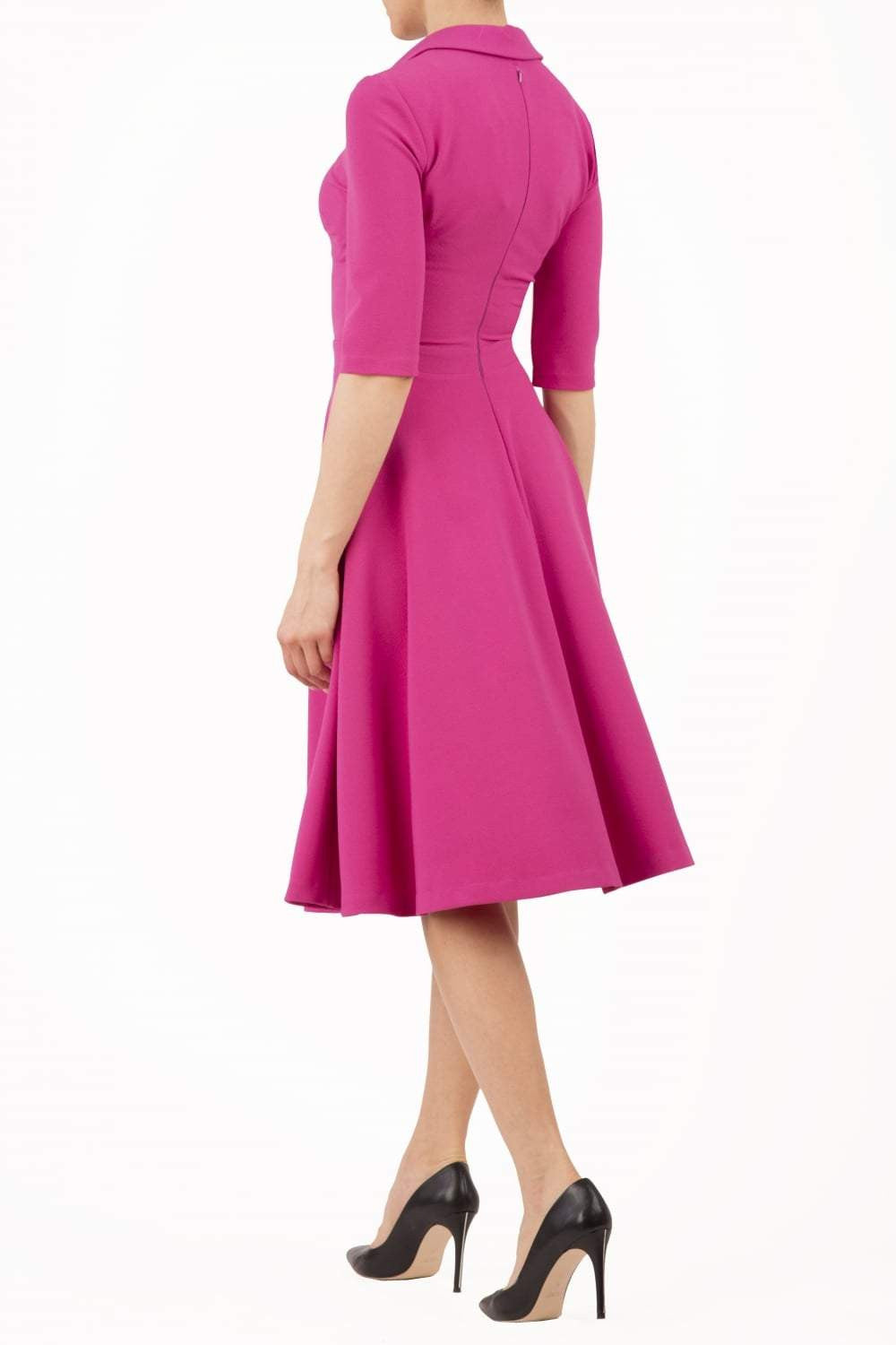 Model wearing the Diva Annette Swing Dress with V shaped neckline with zip detail in fuschia pink back image