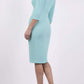 Model wearing the Diva Astra pencil dress with off shoulder design in mint green back image 