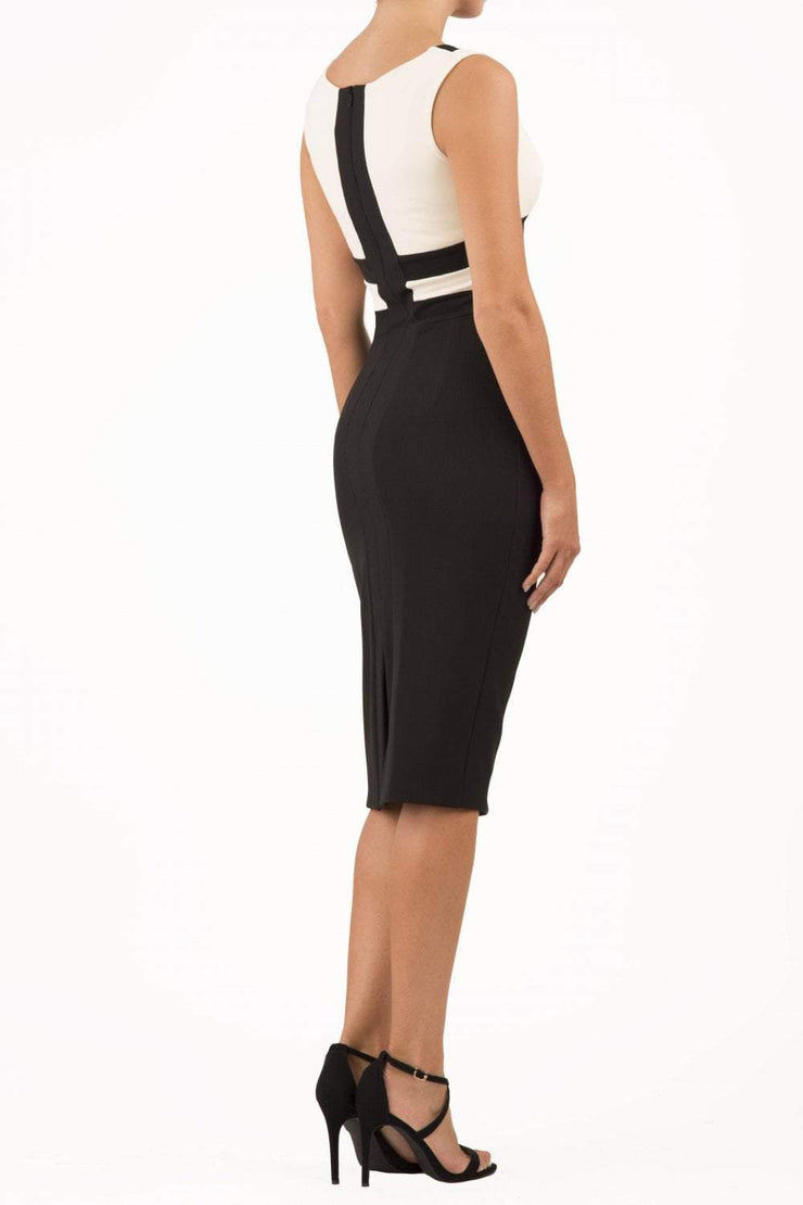 model is wearing duva catwalk banbury sleeveless colour block pencil dress with low v-neck in black and ivory back