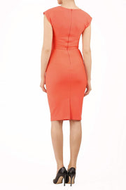 model wearing diva catwalk daphne sleeveless peach pencil dress with rounded neckline with split in the middle in back