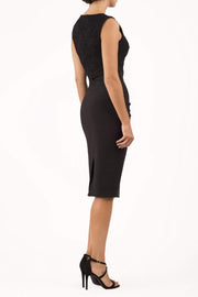 Model wearing the Diva Demelza Lace Pencil dress with lace stretch detailing and round neckline in black back image
