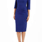 A model is wearing a three quarter sleeve pencil dress with a round neckline and bow detail at the front in oxford blue
