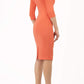 model wearing diva catwalk helston peach pencil dress with sleeves and cut out detail on the neckline back