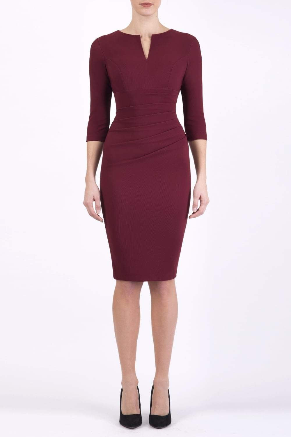 brunette model wearing diva catwalk best selling lydia pencil sleeved dress with slit at the neckline and pleating across the tummy in colour cabaret burgundy front