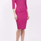 brunette model wearing diva catwalk best selling lydia pencil sleeved dress with slit at the neckline and pleating across the tummy in colour fuchsia pink front