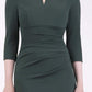 brunette model wearing diva catwalk best selling lydia pencil sleeved dress with slit at the neckline and pleating across the tummy in colour deep green front