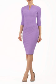 brunette model wearing diva catwalk best selling lydia pencil sleeved dress with slit at the neckline and pleating across the tummy in colour chalk purple front