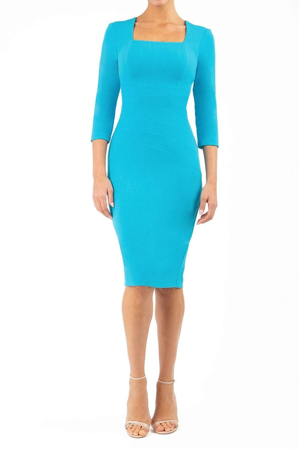 blond model wearing diva catwalk nashville plain pencil skirt dress with sleeves and square neckline and Empire waistline in azure blue colour front