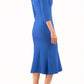 blonde model is wearing diva catwalk senne midaxi sleeved dress with fishtail and rounded neckline with a slit in the middle in cobalt blue front
