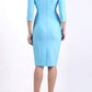 A model is wearing a bistretch pencil three quarter sleeve  and assymetric nackline dress by Diva Catwalk in sky blue