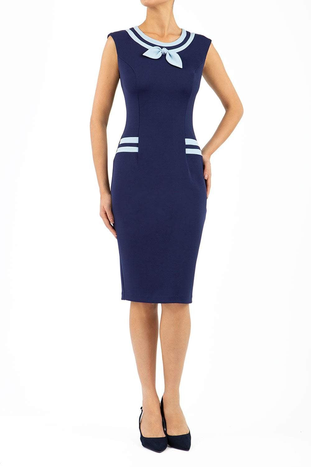 model wearing diva catwalk navy blue tempo pencil dress with pocket detail and rounded neckline with bow detail front