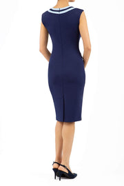 model wearing diva catwalk navy blue tempo pencil dress with pocket detail and rounded neckline with bow detail back