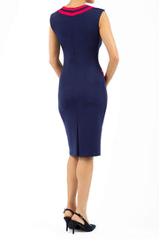 model wearing diva catwalk navy blue tempo pencil dress with pocket detail and rounded neckline with bow detail back