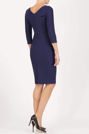 model wearing diva catwalk york pencil-skirt dress with sleeves and rounded folded collar and plearing across the tummy area in navy blue colour back