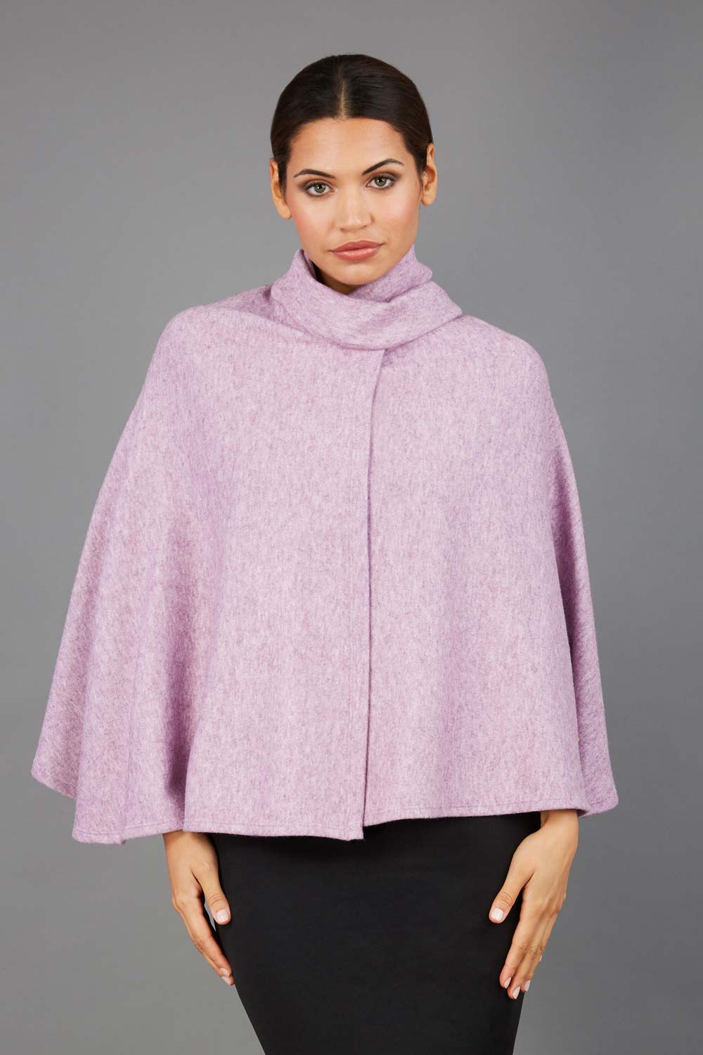 brunette model wearing diva catwalk hampstead cape known as shawl high neck in pink front