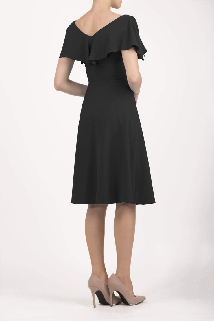 model wearing diva catwalk layla swing dress with bardot frill neckline in black back