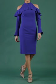 brunette model is wearing diva catwalk liah long sleeve cold-shoulder pencil dress with high neck in spectrum indigo front
