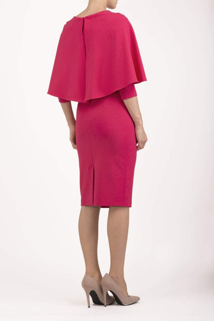 model wearing diva catwalk lizanne pencil-skirt dress with an attached wide cape detail and 3 4 sleeves in colour honeysuckle pink back