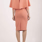 model wearing diva catwalk lizanne pencil-skirt dress with an attached wide cape detail and 3 4 sleeves in colour peach back