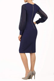 brunette model wearing diva catwalk navy pencil dress with long sleeves knee length and mesh detail sleeves back