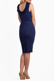 brunette model is wearing diva catwalk odessa pencil sleeveless dress with frill detail on rounded neckline in navy back